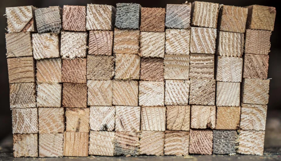 Multiple Timber Fence Posts Stacked In a Grid Pattern Viewed From Bottom