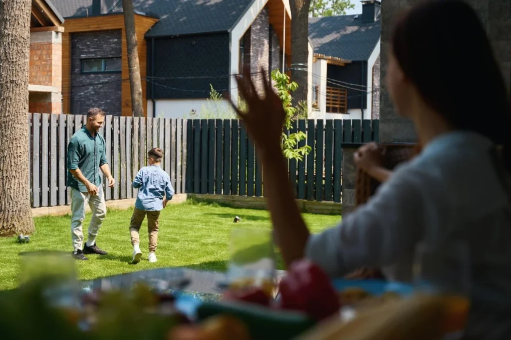 Child playing in Garden with family surrounded by privacy fence